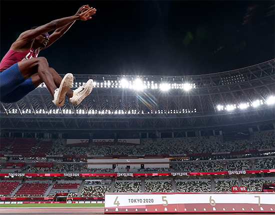 Lex Gillette mid-air in the men's long jump event at the Tokyo 2020 Paralympic Games.