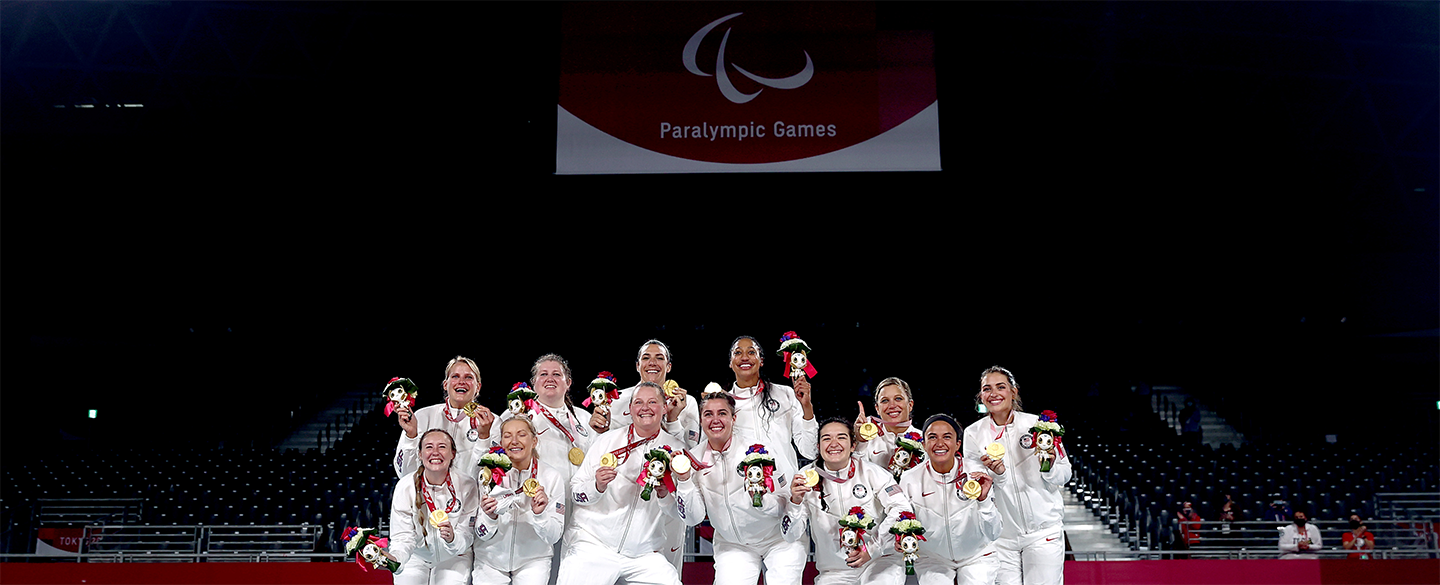 The Women's Sitting Volleyball team hold up their gold medals at the medal ceremony at the Tokyo 2020 Paralympic Games.